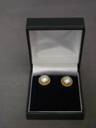 A pair of 9ct gold ear studs set pearls