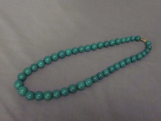 A string of jade coloured hardstone beads