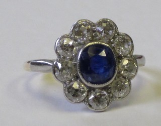 An 18ct white gold diamond dress ring set an oval sapphire surrounded by diamonds