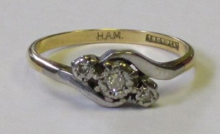 An 18ct gold cross-over dress ring set illusion set diamonds