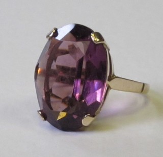 A lady's gold dress ring set an oval cut amethyst