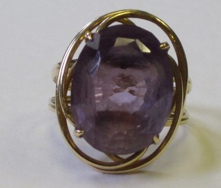 A lady's gold dress ring set an oval pale coloured amethyst