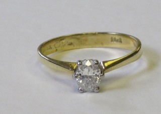 An 18ct yellow gold solitaire dress ring set a diamond