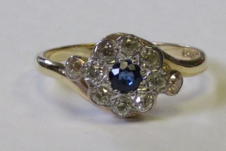A lady's 18ct yellow gold dress ring set a circular sapphire surrounded by diamonds approx 0.50ct