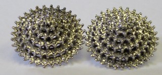 A pair of diamond ear studs set multiple rows of diamonds