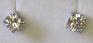 A pair of circular diamond stud earrings, approx 1.42ct