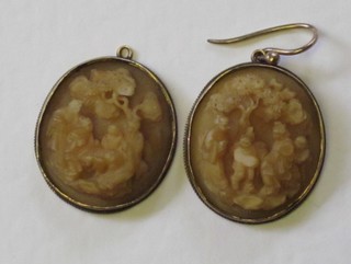 A pair of carved lava earrings