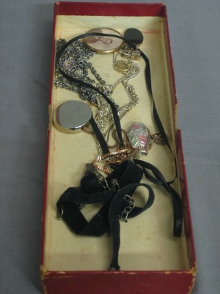 A small collection of costume jewellery including a double sided photo locket and necklaces