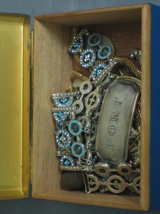 An Art Deco style metal box containing a collection of costume jewellery