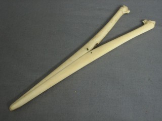 A pair of carved ivory glove stretchers
