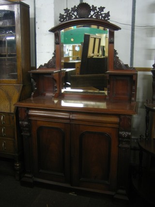 A  Victorian mahogany chiffonier with raised mirrored back fitted 2 niches, the base fitted 2 drawers above a double cupboard enclosed by arch shaped panelled doors 45"