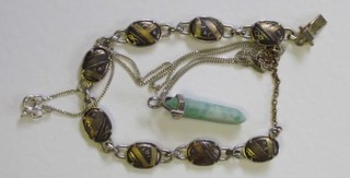 A Niello bracelet together with a carved green hardstone pendant