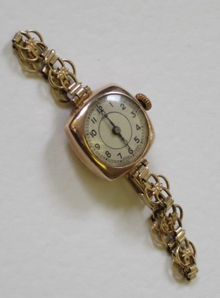 A lady's gold wristwatch contained on an integral gold bracelet
