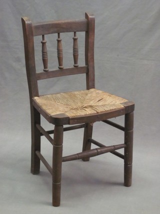 A 19th Century childs beech stick and rail back chair with woven rush seat