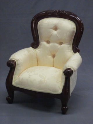 A childs Victorian style mahogany show frame armchair upholstered in yellow material, raised on cabriole supports
