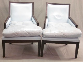 A pair of ebonised show framed arm chairs upholstered in blue material