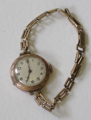 A lady's gold cased wristwatch on an integral bracelet