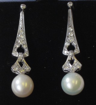 A pair of white gold diamond and pearl drop earrings