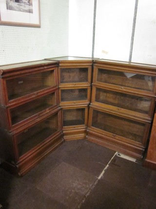 An oak 9 section, 3 tier Globe Wernicke corner bookcase