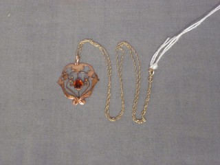 A 9ct pierced gold pendant set a brown coloured stone