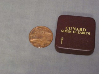 A bronze commemorative metal to commemorate the final voyage of Queen Elizabeth