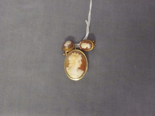 An oval shell carved cameo brooch contained in a gold mount, together with a pair of matching earrings