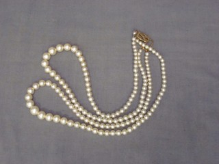 A rope of pearls with gold clasp