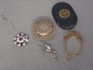 A circular pierced silver filigree pill box with hinged lid, a pair of pince nez and 2 brooches