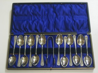 A set of 6 silver plated tea spoons with matching tongs