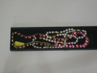 A string of cultured pearls and a pink stone necklace