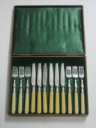 A set of 6 silver plated fruit knives and forks, cased