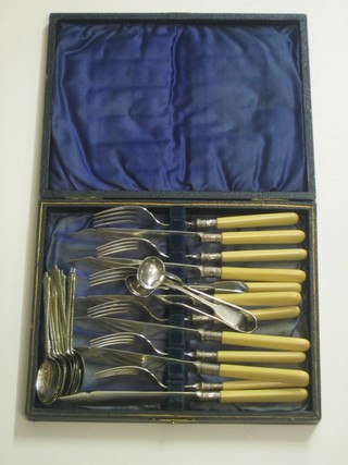 A set of 6 silver plated fruit knives and forks, 12 apostle spoons, a pair of silver plated fiddle pattern mustard spoons and a pair of tongs