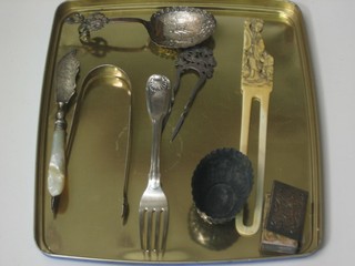 A pair of Georgian silver bright cut sugar tongs, a Georgian silver fiddle pattern fork, a Continental boat shaped salt, do. spoon, silver hair slide, match slip, silver bladed butter knife with mother of pearl handle and an ivory item
