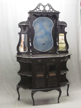 An Edwardian ebonised sideboard with raised mirrored back, the base fitted a drawer with cupboard enclosed by glazed panelled doors, the base flanked by a pair of niches 47"