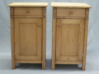 A pair of stripped and polished pine bedside cabinets fitted a drawer above a cupboard 16 1/2"