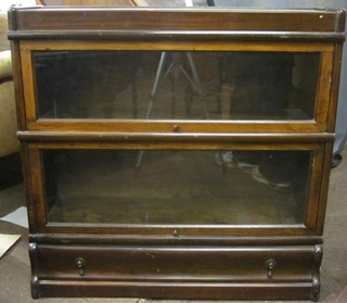A 2 tier mahogany Globe Wernicke bookcase the base fitted a drawer 34"