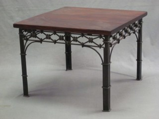 A square hardwood lamp table, raised on a pierced iron base 24"