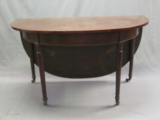 A Georgian mahogany farmers style drop flap gateleg dining table, raised on turned supports 51"
