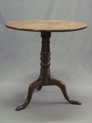 A 19th Century circular mahogany snap top tea table, raised on a gun barrel turned column with tripod base 28"
