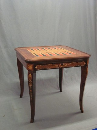 An inlaid mahogany finished lozenge shaped games table, the upper section with inlaid top revealing a backgammon board, a chess board and a roulette wheel with board, 27"