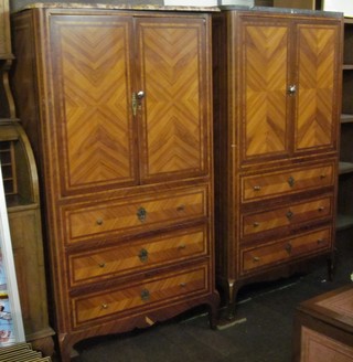 A pair of Continental Kingwood cabinets with marble tops, the interiors fitted trays and enclosed by panelled doors, the base fitted 3 long drawers, raised on cabriole supports 33"