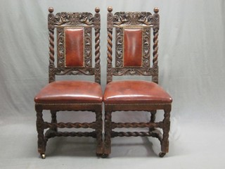 A pair of Victorian carved oak Carolean style high back chairs with upholstered seats, raised on spiral turned and block supports