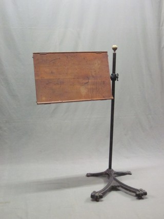 A Victorian rectangular oak reading stand, raised on an iron base 24"