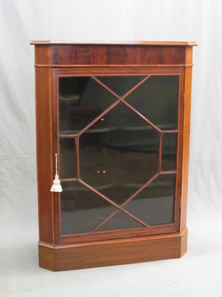 A 19th Century inlaid mahogany corner cabinet, the interior fitted shelves enclosed by astragal glazed panelled door 32"