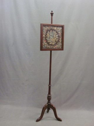 A Victorian mahogany pole screen with square shaped banner with Berlin woolwork decoration
