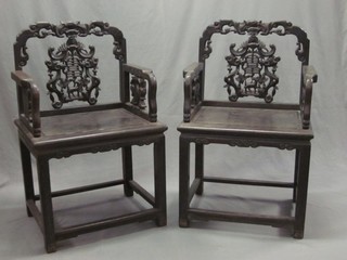 A pair of 19th Century carved Oriental throne chairs