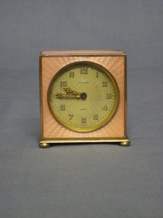 An 8 day bedroom timepiece by Kienzle, contained in a pink enamelled case 2 1/2"