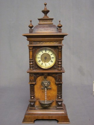 A 19th Century German fountain clock with 3" circular dial, contained in a walnut case
