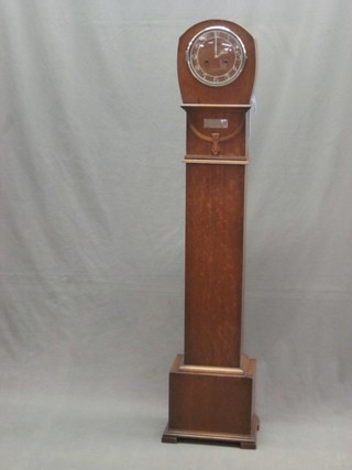 An Art Deco striking Granddaughter clock with Arabic numerals contained in an oak case 51"
