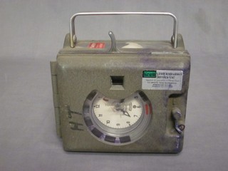 A pigeon racing clock contained in an aluminium case